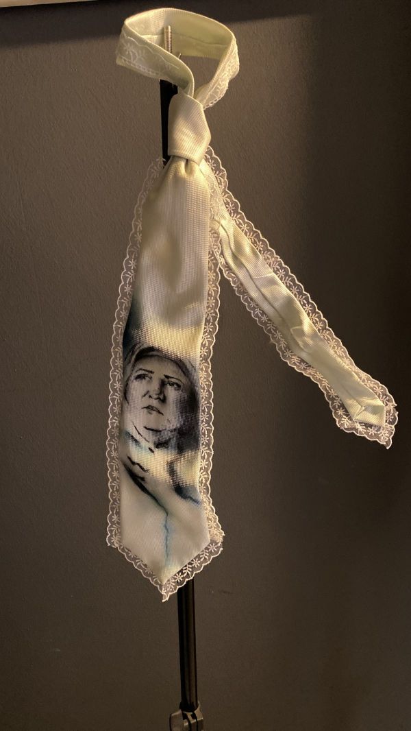 My Mother’s Tie, 2025, Ink on textile / lace embroidery, 55 × 30 cm.